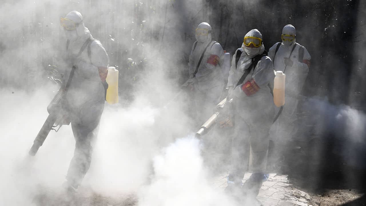 This photo shows members of a police sanitation team spraying disinfectant as a preventive measure against the spread of the COVID-19 coronavirus in Bozhou, in China.